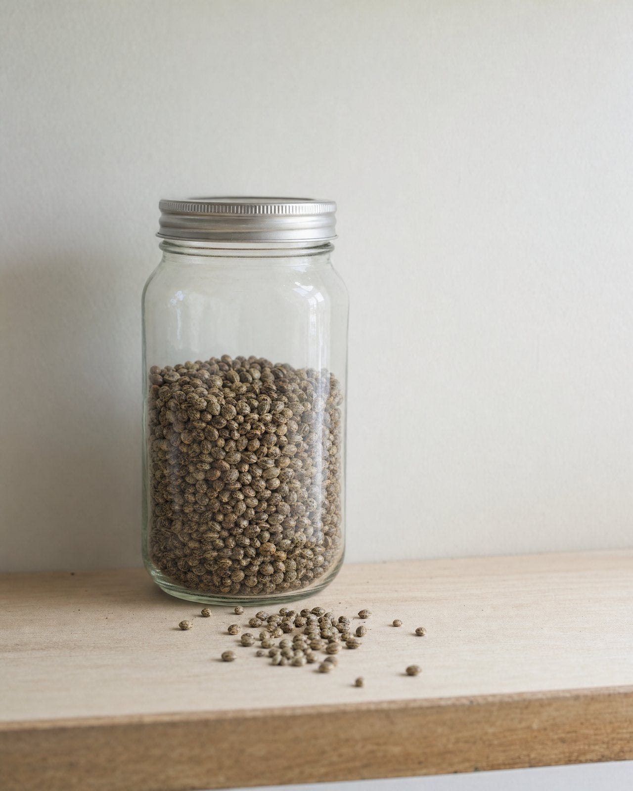 A glass jar of hemp seed on a pantry shelf