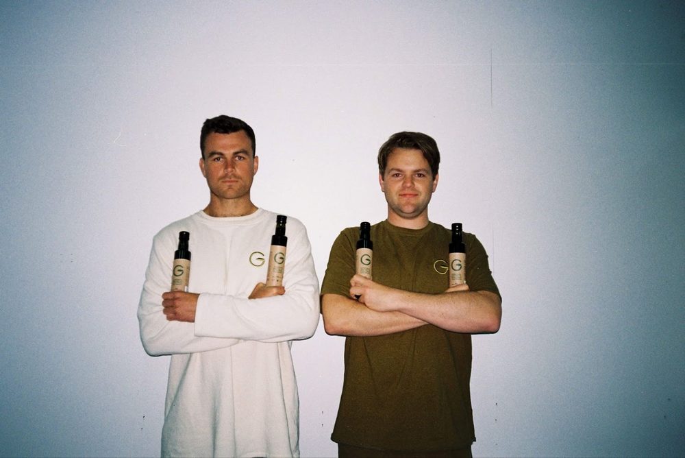 The Brothers Green co-founders in the early days, arms crossed holding the first bottles