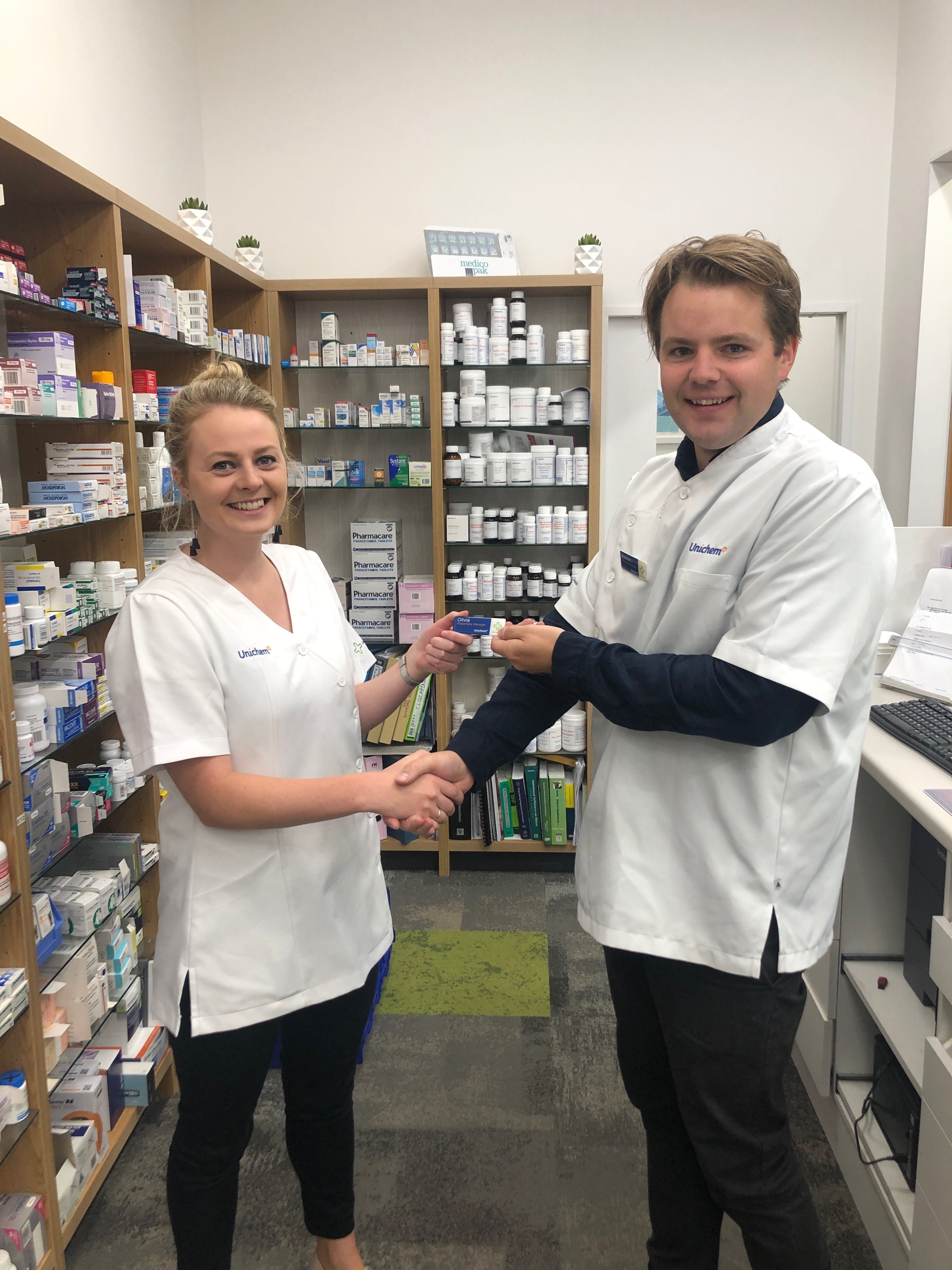 Brendon handing over his badge on his last day at Cashel Pharmacy.