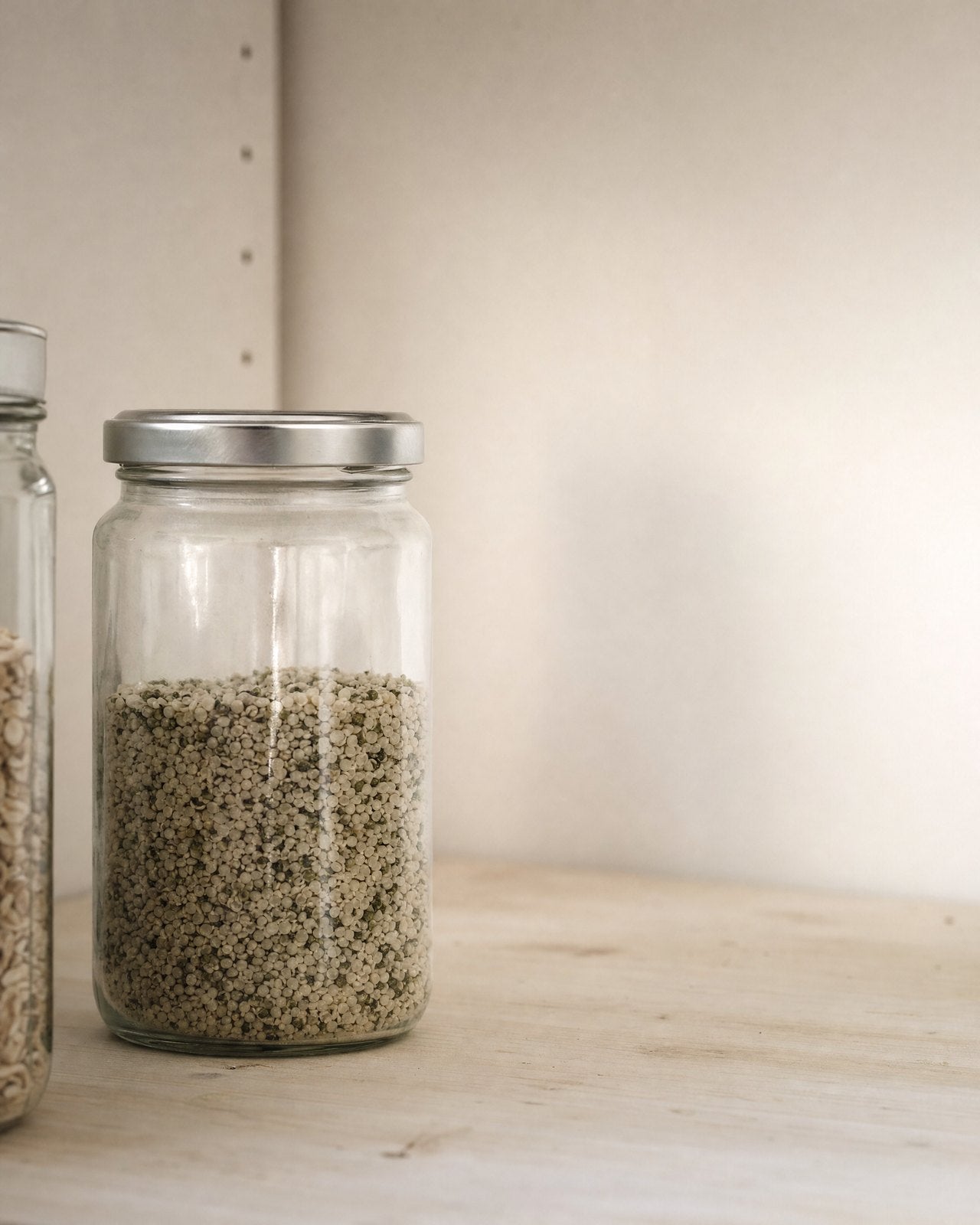 A glass jar of hemp seed on a pantry shelf